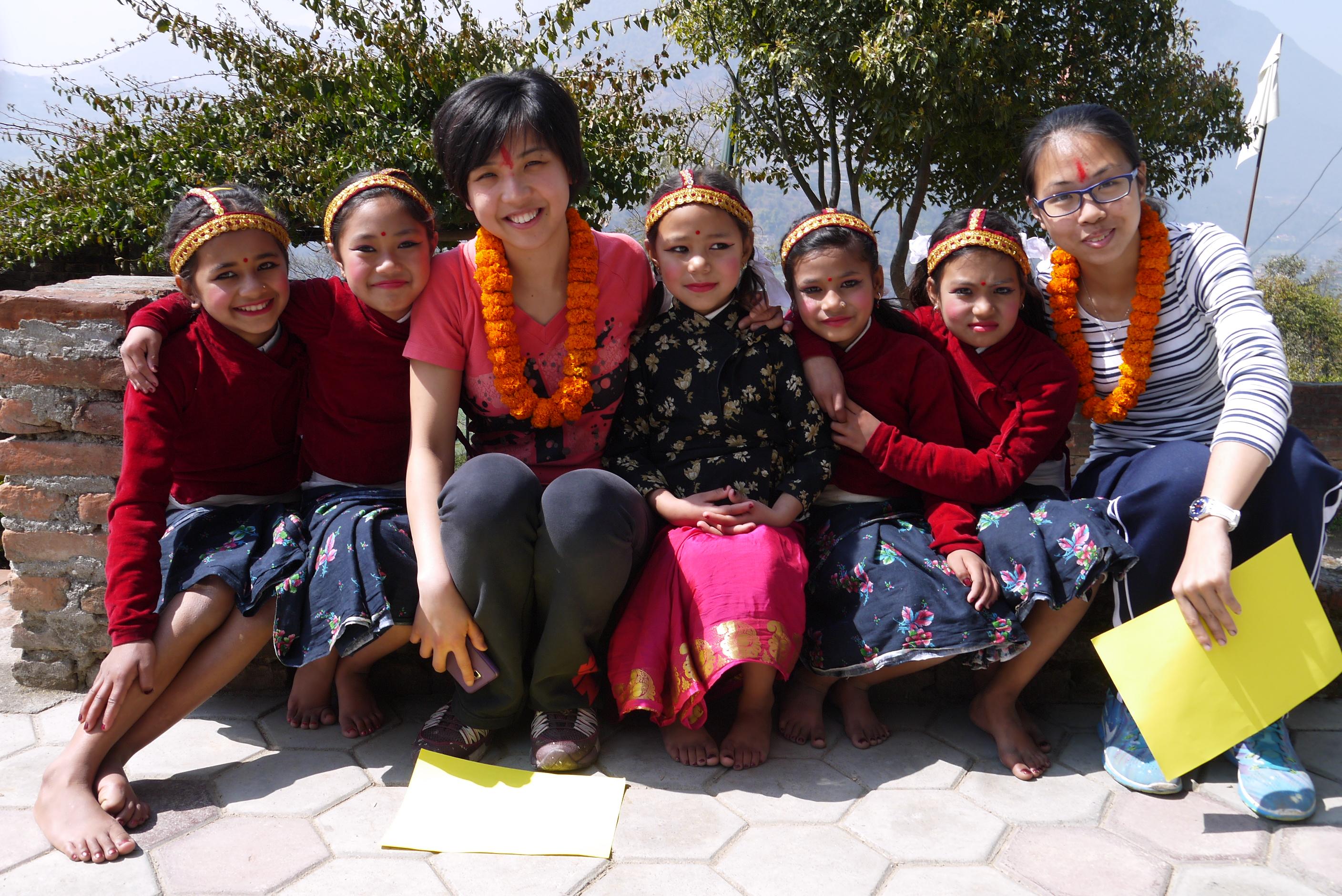 Volunteers on a group trip take a photo with children at their placement during their childcare work in Nepal. As part of community work in Nepal, Projects Abroad volunteers on a group trip learn about each other’s cultures.